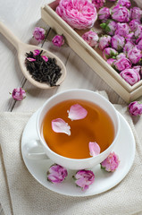 Cup of tea with rose petals