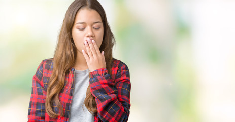 Young beautiful brunette woman wearing a jacket over isolated background bored yawning tired...