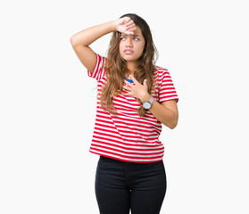 Obraz na płótnie Canvas Young beautiful brunette woman wearing stripes t-shirt over isolated background Touching forehead for illness and fever, flu and cold, virus sick