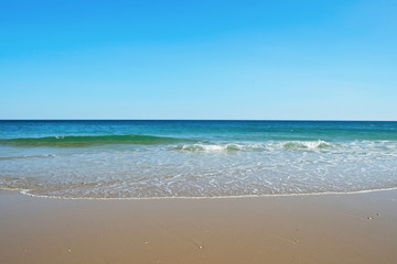 Fototapeta na wymiar Beautiful panoramic view of sandy beaches somwhere in Algarve, Portugal. Copy space for text, clean turquoise Ocean water background.