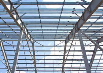 The structure of the steel frame for building construction on sky background. Zinc metal coating to protect against corrosion. 