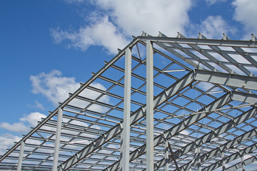 The structure of the building. Steel construction on the sky background. Electroplate steel metal....
