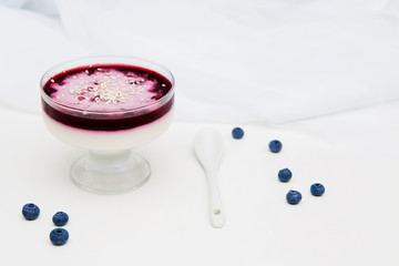 Creamy Blueberry jelly and sesame in glass vase with white spoon