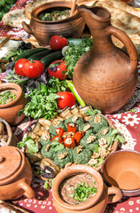 Fototapeta premium Georgian food Lobio vegetables herbs Dinner table