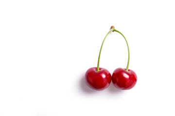 Ripe red cherries isolated on white background