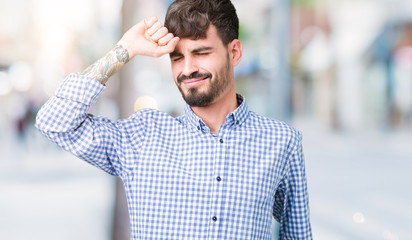 Young handsome business man over isolated background stretching back, tired and relaxed, sleepy and yawning for early morning