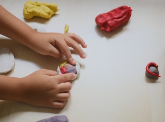 kids playing with play dough over white background