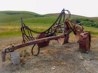 Lajatico - Pisa - 25 May 2019 - Old plow machine in a field of Tuscany.