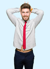 Young handsome business man Posing funny and crazy with fingers on head as bunny ears, smiling cheerful