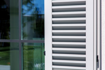 wooden shutters of gray color, close up of the exterior of the house in the Italian style.