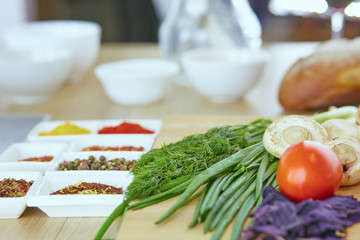 Composition with wooden board and ingredients for cooking on table