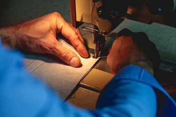 man using sewing machine