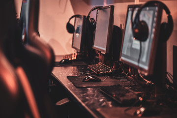 Empty comfortable studio for professional gamers with computers and earphones.