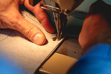 man using sewing machine