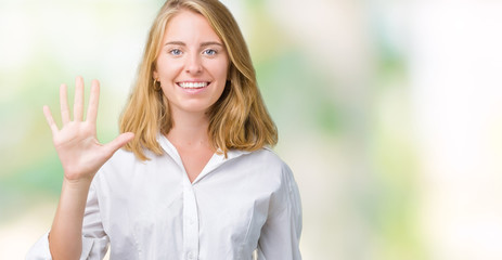 Beautiful young business woman over isolated background showing and pointing up with fingers number...
