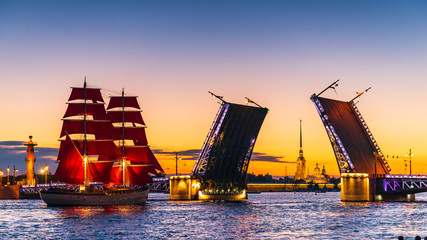 Ship with red sails sails on the Neva. Preparation for the holiday of all schoolchildren "Scarlet Sails" in St. Petersburg