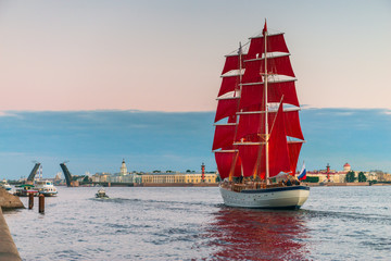 Ship with red sails sails on the Neva. Preparation for the holiday of all schoolchildren "Scarlet Sails" in St. Petersburg