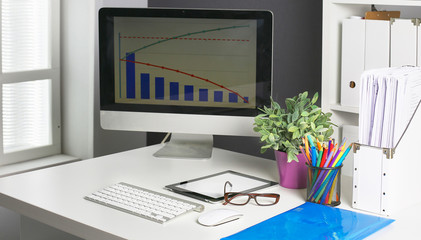Stylish workspace with desktop computer, office supplies, houseplant and books at office. desk work concept.