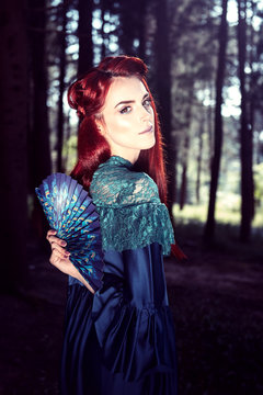 Female portrait with peacock feather on foreground. beauty makeup.
