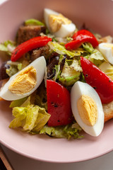 Close up of traditional american cobb salad with chopped avocado, tomatoes, hard boiled egg, roasted chicken and greens for a healthy lunch