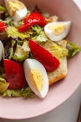 Close up of traditional american cobb salad with chopped avocado, tomatoes, hard boiled egg, roasted chicken and greens for a healthy lunch