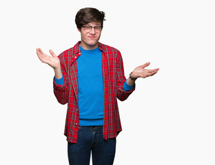 Young handsome student man wearing glasses over isolated background clueless and confused...