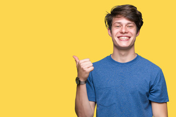 Young handsome man wearing blue t-shirt over isolated background doing happy thumbs up gesture with...