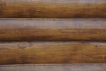 brown wooden texture of wide planks in the wall of the fence