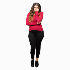 Fototapeta premium Young beautiful woman wearing red sweater thinking looking tired and bored with depression problems with crossed arms.