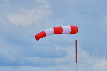 Windsock during a strong wind. Windsock shows wind direction and strength. Made of fabric in the form of a cone. It is installed at the airports of small aircraft