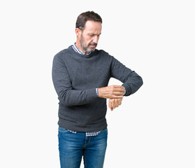 Handsome middle age senior man wearing a sweater over isolated background Checking the time on wrist watch, relaxed and confident