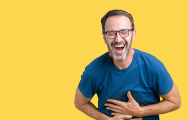 Handsome middle age hoary senior man wearin glasses over isolated background Smiling and laughing...