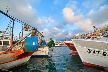 Obraz premium DENIA, SPAIN - JUNE 13, 2019: Fishing boat with ropes in the port of Denia town.
