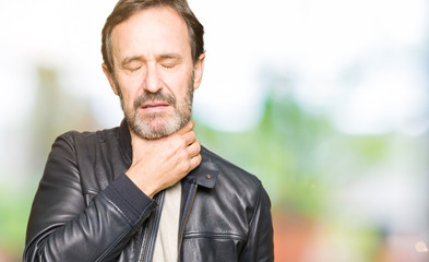 Middle age handsome man wearing black leather jacket Touching painful neck, sore throat for flu, clod and infection