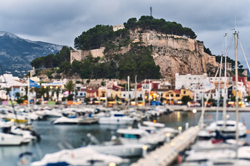 Fototapeta na wymiar DENIA, SPAIN - JUNE 13, 2019: Panoramic view of Denia port promenade and castle.