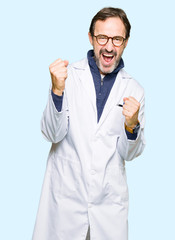 Middle age therapist wearing white coat very happy and excited doing winner gesture with arms raised, smiling and screaming for success. Celebration concept.