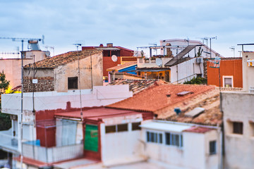 DENIA, SPAIN - JUNE 13, 2019: Old town of Denia view with houses with tile roofs