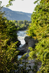 River flow in the mountains among the trees in the stone bed of the Hajokh canyon. Adygea....
