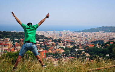Man dressed in green jumping on the mountain.