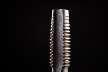 Manual device for thread cutting in metal. Locksmith accessories for small work in a home workshop.