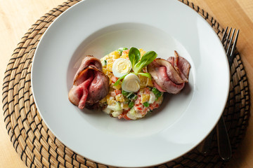 Fancy salad with thai style marbled beef with greens, crunchy cucumber, bell pepper and green peas
