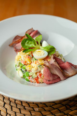Close up of luxurious salad with thai style marbled beef with greens, crunchy cucumber, bell pepper and green peas