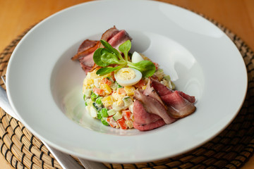 Fancy salad with thai style marbled beef with greens, crunchy cucumber, bell pepper and green peas