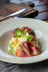 Fancy salad with thai style marbled beef with greens, crunchy cucumber, bell pepper and green peas