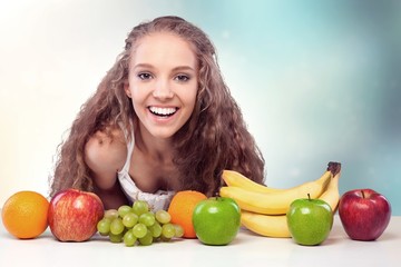 Attracive young woman enjoying tea and fruits on breakfast