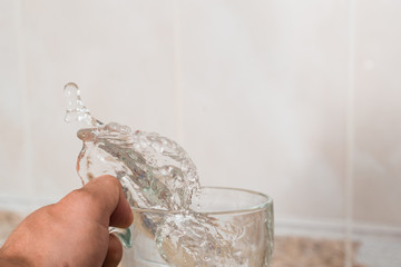 Water spills out of the cup.