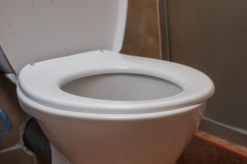 White toilet in a hotel room. Hygiene in a public place.