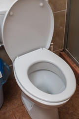 White toilet in a hotel room. Hygiene in a public place.