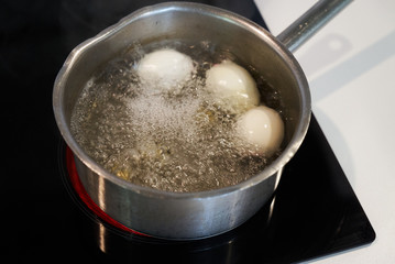 Preparing food on casserole pan on a electric stove, close-up. Cook egg process