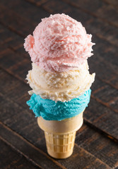 Red White and Blue Scoops of Ice Cream on a Cone on a Wood Table